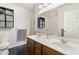 Bright bathroom with double vanity, modern fixtures, and a decorative cabinet for towels and toiletries at 1110 Flyway Rd, Summerville, SC 29483