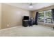Neutral bedroom featuring a large window with blinds, carpeted floors, and a ceiling fan for comfort at 1110 Flyway Rd, Summerville, SC 29483