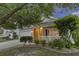 Inviting front exterior with a well-maintained lawn, a covered front porch, and manicured landscaping at dusk at 1110 Flyway Rd, Summerville, SC 29483