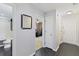 Hallway with dark wood floors leading to other rooms, including a bathroom and a bedroom/office space at 1110 Flyway Rd, Summerville, SC 29483