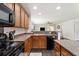 Well-lit kitchen featuring wood cabinets, modern appliances, and an island counter-top extending out to the Gathering room at 1110 Flyway Rd, Summerville, SC 29483