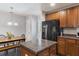 Kitchen with island, stainless refrigerator and wood cabinets, and dining table at 1110 Flyway Rd, Summerville, SC 29483