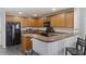 Well-equipped kitchen with wooden cabinets, a black appliance package, and breakfast bar seating at 1110 Flyway Rd, Summerville, SC 29483