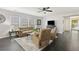 Bright living room featuring a comfortable seating arrangement, ceiling fan, and large windows for natural light at 1110 Flyway Rd, Summerville, SC 29483
