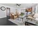 Inviting living room with an open layout, a ceiling fan, a patterned rug, and an eat-in kitchen with barstool seating at 1110 Flyway Rd, Summerville, SC 29483