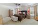 Cozy main bedroom featuring a ceiling fan, two windows, a bed with an assortment of pillows, and a dresser at 1110 Flyway Rd, Summerville, SC 29483