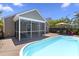 Beautiful backyard featuring an in-ground pool and screened-in porch with outdoor furniture and patio for entertaining at 1110 Flyway Rd, Summerville, SC 29483