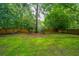 Large, flat backyard with healthy green lawn, wooden fence, and a boat at 113 Essex Dr, Summerville, SC 29485