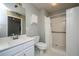 Bathroom with white vanity, toilet, shower, and decorative wall art at 113 Essex Dr, Summerville, SC 29485