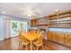 Spacious dining room featuring a fireplace, built-in cabinets, hardwood floors, and access to the backyard at 113 Essex Dr, Summerville, SC 29485