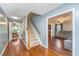 Welcoming entryway showcasing hardwood floors, staircase, and seamless flow to the living spaces at 113 Essex Dr, Summerville, SC 29485