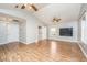 Open-concept living room with wood laminate flooring, ceiling fans, and access to bathroom at 113 Essex Dr, Summerville, SC 29485