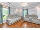 Living room featuring hardwood floors, ample natural light, and comfortable seating with reclining sofas at 113 Essex Dr, Summerville, SC 29485