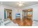 Open concept living room with hardwood floors, comfortable seating, and open access to dining and other living areas at 113 Essex Dr, Summerville, SC 29485