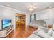 Open living area with hardwood floors, grey sofas, and views into the dining area and additional spaces at 113 Essex Dr, Summerville, SC 29485