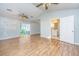 Open living room with wood laminate flooring, bathroom access, and sliding glass doors to the backyard at 113 Essex Dr, Summerville, SC 29485