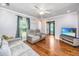Living room with hardwood floors, natural light, and a modern television setup, open to other areas of the home at 113 Essex Dr, Summerville, SC 29485