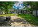 Large backyard with brick patio, fire pit, screened in porch, and a blue exterior at 115 Sully St, Goose Creek, SC 29445