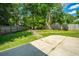 A wooden fence encloses the spacious backyard with stone path and lush green space at 115 Sully St, Goose Creek, SC 29445