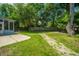Spacious backyard features a stone path, concrete patio, and lush green space at 115 Sully St, Goose Creek, SC 29445