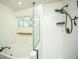 Bathroom showcasing a soaking tub and separate shower behind a glass partition, bathed in natural light at 115 Sully St, Goose Creek, SC 29445