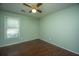 Bedroom with green walls, wood-look flooring, a ceiling fan, and a window with blinds at 115 Sully St, Goose Creek, SC 29445