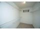 Bright walk-in closet featuring white walls, carpet, and multiple wire shelves for ample storage at 115 Sully St, Goose Creek, SC 29445