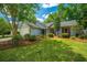 Charming single-story home with light blue siding, lush green lawn and tasteful landscaping at 115 Sully St, Goose Creek, SC 29445