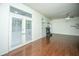 Well-lit living room with hardwood floors, fireplace, and French doors leading to the outdoor space at 115 Sully St, Goose Creek, SC 29445