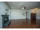 Open living area with a decorative fireplace, hardwood floors, and shelving details at 115 Sully St, Goose Creek, SC 29445