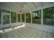 Bright sunroom with tiled floor, white walls, and a ceiling fan overlooking the backyard at 115 Sully St, Goose Creek, SC 29445