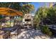 Backyard patio features a built in brick oven, outdoor dining set, and manicured landscaping at 1153 King St, Charleston, SC 29403