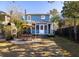 Charming backyard featuring a patio with outdoor seating, pizza oven and a well-maintained lawn, great for entertaining at 1153 King St, Charleston, SC 29403