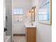 Cozy bathroom featuring a vintage vanity, globe sconces, and artistic wall decor at 1153 King St, Charleston, SC 29403
