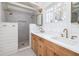 Bright bathroom features a double vanity with modern fixtures and a separate shower at 1153 King St, Charleston, SC 29403