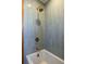 Modern bathroom with vertical blue tiling, shower fixture and soaking tub at 1153 King St, Charleston, SC 29403