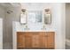 Bright bathroom features a double vanity with modern fixtures and a separate shower at 1153 King St, Charleston, SC 29403