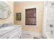 This bright bathroom features a marble countertop, stylish fixtures, and a luxurious shower-tub combination at 1153 King St, Charleston, SC 29403