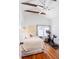 Cozy bedroom featuring exposed wood beams, a ceiling fan, a stationary bike, and natural light from a window at 1153 King St, Charleston, SC 29403