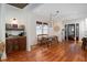 Charming dining room featuring hardwood floors, natural light, and a vintage-style chandelier fixture at 1153 King St, Charleston, SC 29403