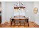Bright dining room features hardwood floors, white walls, large window, and stylish chandelier, perfect for entertaining at 1153 King St, Charleston, SC 29403