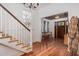 Classic foyer showcasing hardwood floors, staircase and wooden front door with charming details at 1153 King St, Charleston, SC 29403