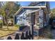 Inviting home exterior with blue siding, a brick porch, and a neatly landscaped front yard for curb appeal at 1153 King St, Charleston, SC 29403