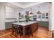 Open concept kitchen with a central island, white cabinetry, and modern stainless steel appliances at 1153 King St, Charleston, SC 29403