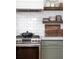 Modern kitchen with stainless steel appliances, white subway tile, and wooden floating shelves at 1153 King St, Charleston, SC 29403