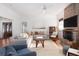 Comfortable living room with a large sofa, fireplace, and ample natural light, perfect for relaxation and entertaining at 1153 King St, Charleston, SC 29403