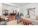 Open-concept living room showcasing hardwood floors, stylish furnishings, and a seamless flow to the kitchen at 1153 King St, Charleston, SC 29403