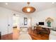 Relaxing living room features a lounge chair, modern desk, and hardwood floors, perfect for unwinding or working at 1153 King St, Charleston, SC 29403