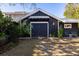 Charming shed with carriage doors, stone pathway, and outdoor lighting, perfect for a workshop or storage at 1153 King St, Charleston, SC 29403