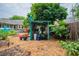 Picturesque backyard featuring a charming shed, raised garden beds, and mature trees, offering a peaceful setting at 1158 Shoreside Way, Mount Pleasant, SC 29464